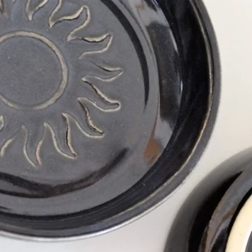 appetizer plate, black with sun stamp in middle