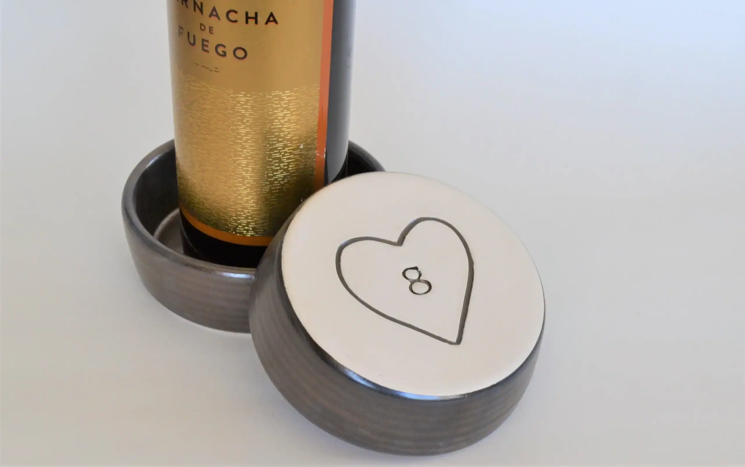 brone poottery wine coaster with engraved heart on the bottom